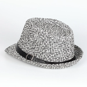 Close-up of Panama straw hat featuring black and white weave with leather buckle strap