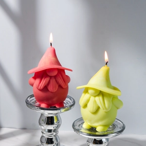 Detailed pair of red and yellow gnome candles with intricate woven hat textures