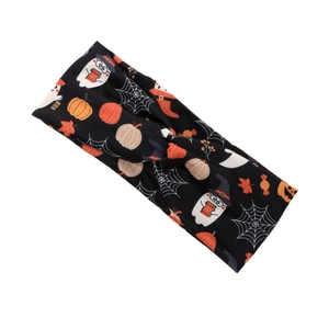 Halloween wide headband with pumpkins, skulls and ghosts print in a twisted knot style
