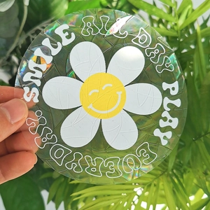 Macro shot of circular daisy flower window sticker with iridescent holographic prism effect