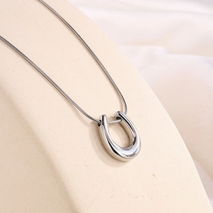 Elegant silver U-shape pendant necklace with snake chain in a minimalist luxury style