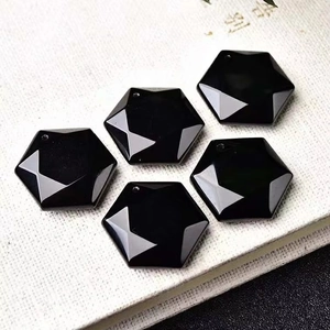Polished black obsidian hexagram pendants showing geometric facets and natural luster