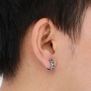 Close-up of silver cuban link hoop earring worn by a male model for a trendy look