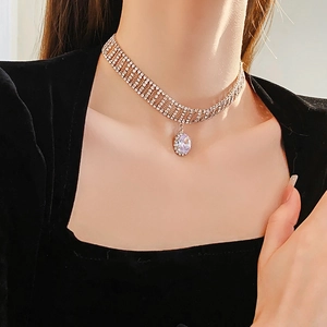 Detail shot of a multi-row rhinestone choker featuring a lavender oval crystal pendant