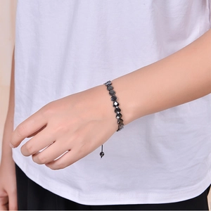 Adjustable heart-shaped black hematite beaded bracelet shown on a female wrist