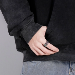 Close-up of a wide rock hip-hop titanium steel ring with colorful woven texture on finger