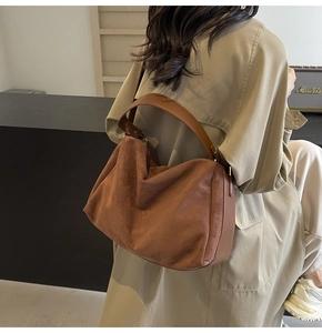 Close-up of brown suede hobo bag with vintage texture and large capacity design