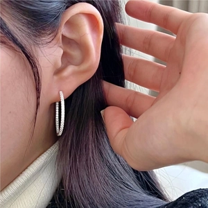 Minimalist 925 sterling silver hoop earrings with white zircon micro-pave on a model