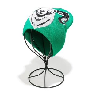 Detailed knit texture of a green Grinch character beanie on a metal display head