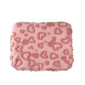 Pink plush tablet sleeve with 3D heart pattern and gold zipper for laptop storage