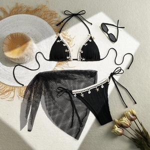 Detailed close-up of black ribbed bikini set with seashell and starfish pendants