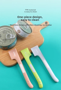 Three-piece TPR pet food can spoons set in pink, green and white on a wooden board