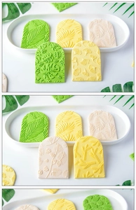Close-up of fondant molds featuring monstera and palm leaf patterns in green and yellow