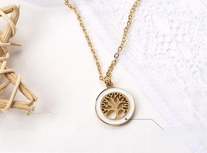 Macro view of stainless steel tree of life necklace with eco-friendly white oil inlay