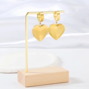 Elegant 18k gold plated stainless steel heart dangle earrings on a luxury display