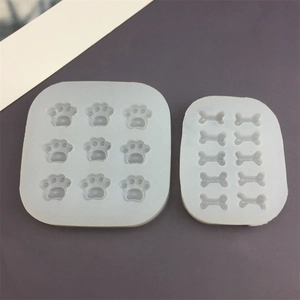 Flat lay of 9-cavity cat paw and 10-cavity bone silicone baking molds for DIY