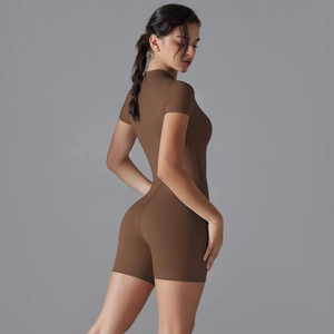 Detail shot of deep brown yoga romper showing the zip-up collar and premium elastic fabric