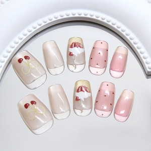 Press-on nails featuring cherry patterns, pink cat-eye effects, and elegant French tips