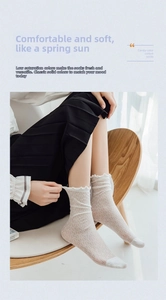 Detail of white lace mesh crew socks featuring sweet ruffle trim and floral hollow pattern