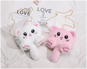 Detail of cute plush cat bags in pink and white with metal chain straps and paw embroidery