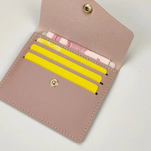 Slim dusty pink card holder wallet in textured leather with gold snap and multi-slots
