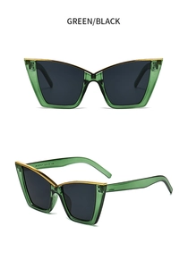 Detail view of translucent green cat-eye sunglasses with gold metal trim and grey lenses