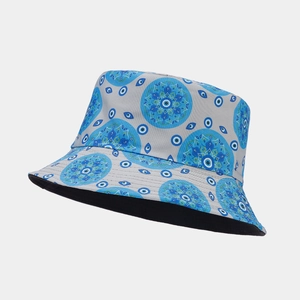 Detail of light grey bucket hat featuring blue mandala and evil eye patterns with black lining