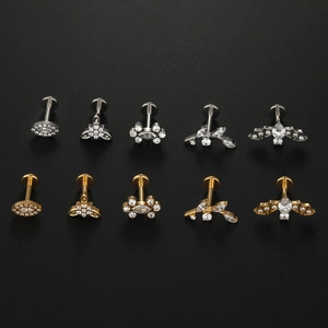 Detailed set of titanium labret studs featuring bat leaf and floral zircon designs