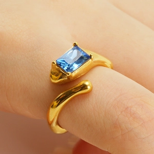 Vintage gold adjustable moonstone ring with a rectangular blue stone in a minimalist style