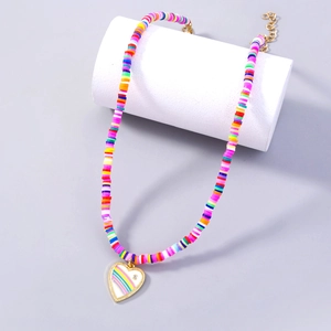 Colorful bohemian polymer clay beaded necklace with a rainbow heart pendant on display