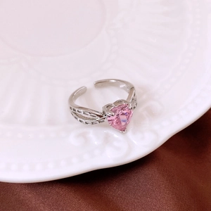 Detail view of heart-shaped pink zircon inlay on a silver adjustable open ring