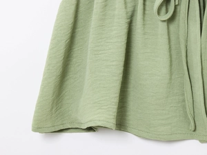 Detail of sage green cotton linen wide-leg pants with adjustable drawstring waist