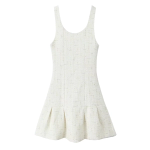 Detail of white tweed sleeveless mini dress showing textured fabric and pleated hemline