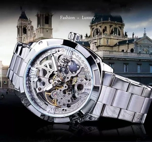 Detailed close-up of a silver skeleton automatic watch with Roman numerals and gears