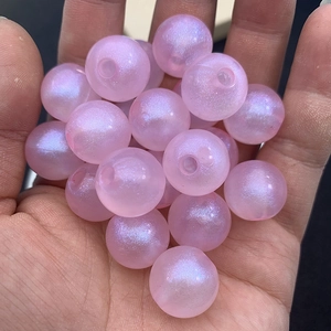 Macro shot of shimmering pink luminous beads for DIY jewelry and hair accessories