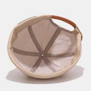 Interior view of beige docker hat showing six-panel construction and leather strap