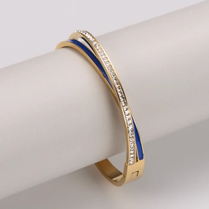 Twisted gold stainless steel bangle with blue enamel and sparkling cubic zirconia crystals
