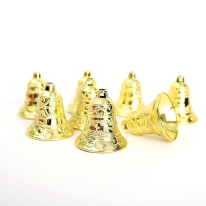 Set of decorative golden Christmas bells with intricate engravings on white background