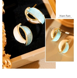 Detail of vintage French enamel hoop earrings with blue and cream pearlescent finish