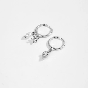 Macro shot of S925 sterling silver hoop earrings with seashell starfish and pearl charms