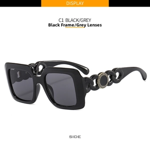 Detail of square sunglasses featuring bold chain temple with gold Greek key logo