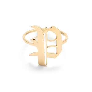 Close-up of vintage gold letter P ring featuring a gothic style monogram and minimalist band