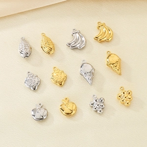 Assorted gold and silver fruit-shaped hollow pendants including strawberry banana and grape