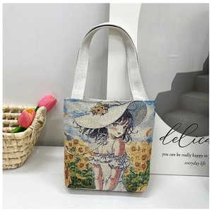 Detail of canvas tote bag featuring an embroidered girl and sunflower field pattern