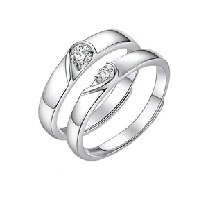 Matching heart-shaped couple rings in silver finish with adjustable open-band design