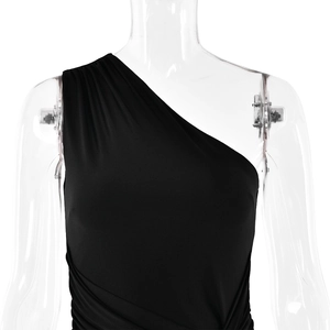 Detailed close-up of black one-shoulder dress with elegant pleats on a mannequin
