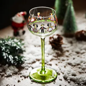 Artistic Christmas tall wine glass with colorful folk figures and festive green stem base