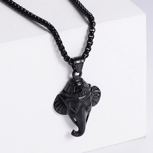 Retro hip hop style black stainless steel elephant head pendant necklace on a white pedestal
