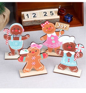 Set of four wooden gingerbread man table ornaments with festive JOY sign and candy canes
