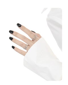Close-up of minimalist double-layer and crisscross silver rings on a model's hand